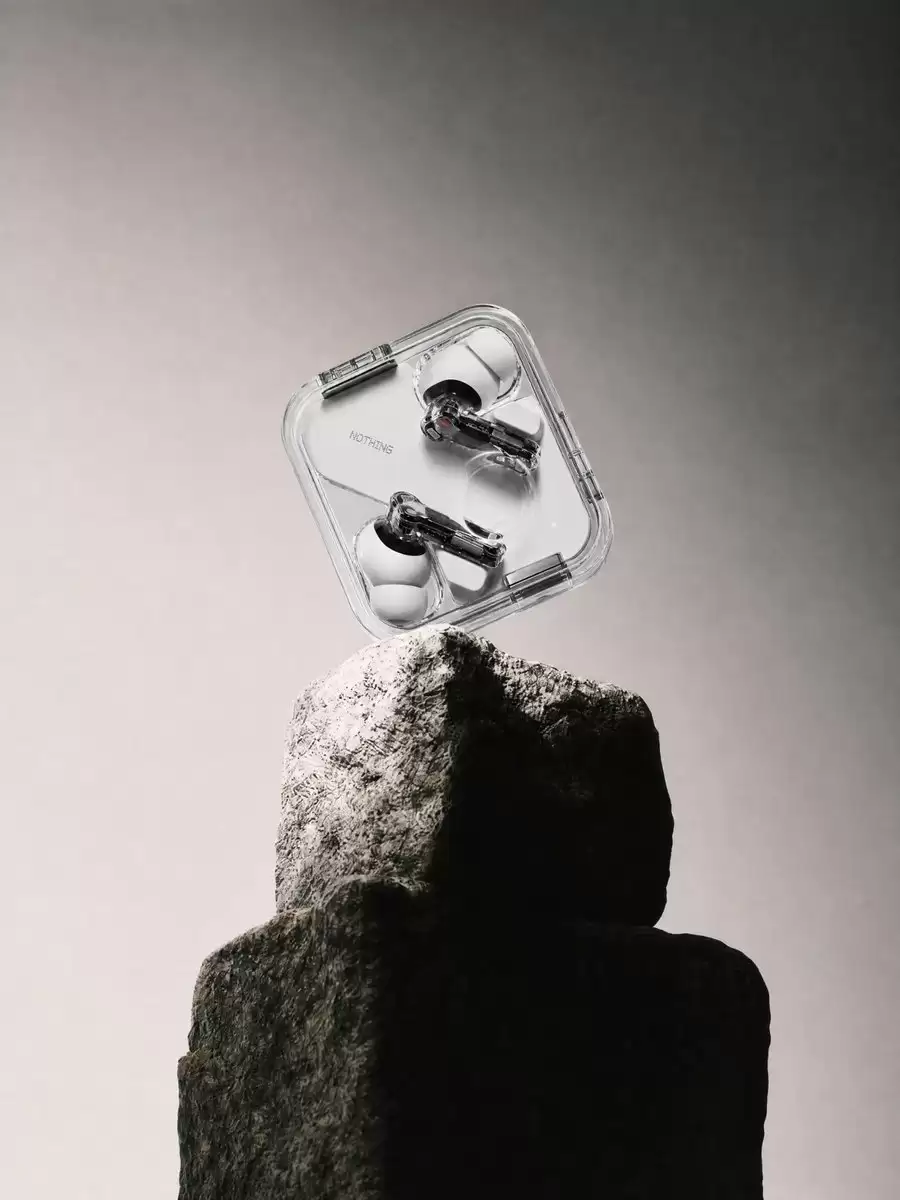 Transparent Earbuds on Stone Pedestal